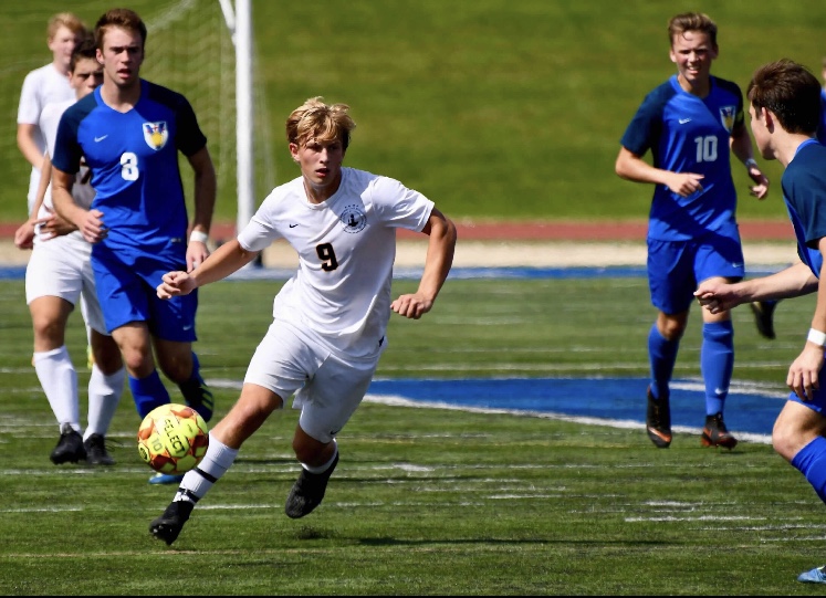 Senior Adam Zukowski looks to move the ball and create a scoring opportunity. In soccer, as a forward, its more important to be  mentally tough because your whole team is relying on you, Zukowski said.