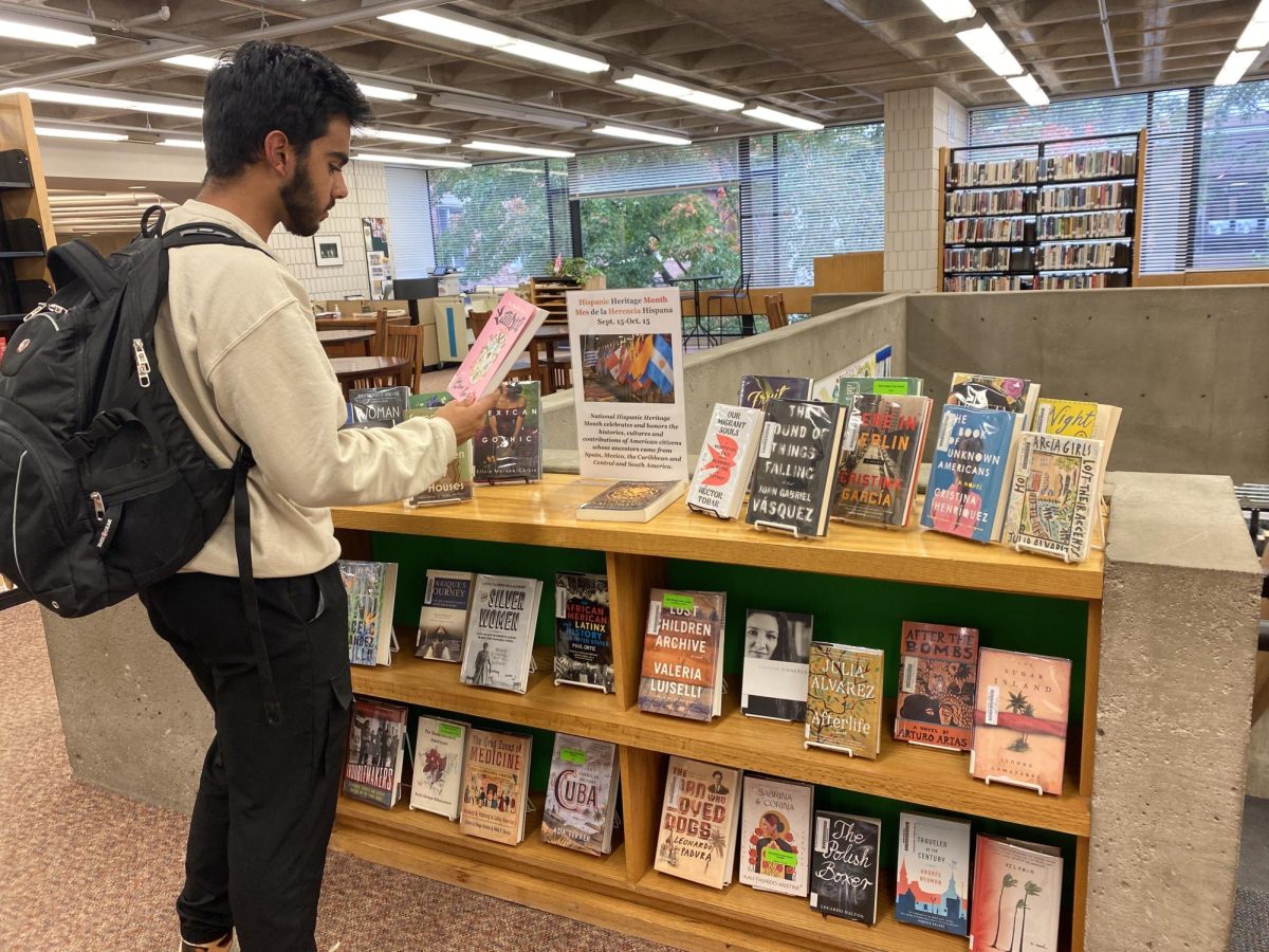 CURIOUS MINDS. Senior Humza Murad checks out the Hispanic Heritage Month library display. These topical displays highlight books that are fun to read and informative.