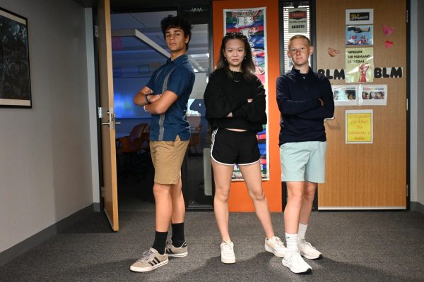 BLUE OUT. Sophomores Aldegundo Brenneman, Ann Li and Caden Deardurff posed in their dark blue outfits. "This is my dad's shirt," Brenneman said of the shirt, which is from Mexico. Li and Deardurff instead opted for casual clothes near the top of their wardrobes, choosing new accessories rather than clothes. "I got my earrings at American Eagle," said Li, who chose a pair shaped like butterflies. Deardurff described his favorite part of his outfit as his new shoes.