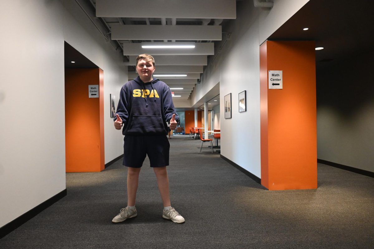 THUMBS UP. Junior Howard Huelster shows off his Spartan hoodie for the first day of school. "It was clean, so I wore it. There wasn't much thought going into it," Huelster said.