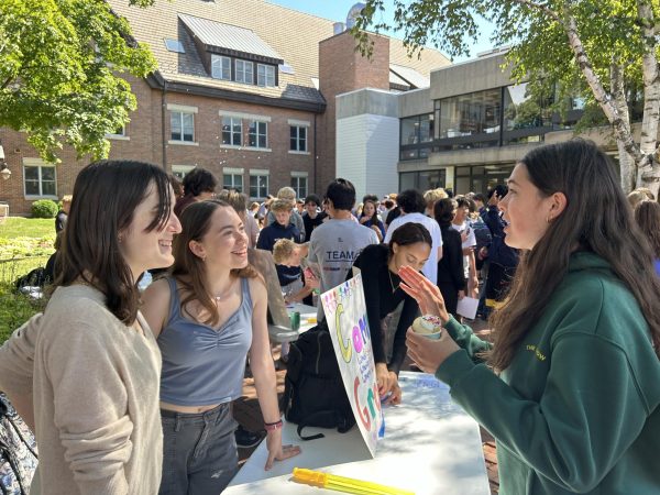 CLUB FAIR CHAT TIME. Senior Ava Schulender and Senior Cassandra Overholt discuss club sign-ups. “It can get easy to get wrapped up in the whole idea of ‘I need to focus on school and get good grades’. That’s all important but you can forget to enjoy the not-school part of school.” Schonwald said.