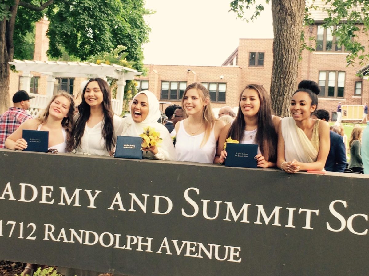 CLASS OF 2015. Alexis Irish, second from the right, graduated in 2015. She poses with her friends in a white dress, a graduation tradition, holding her diploma. 