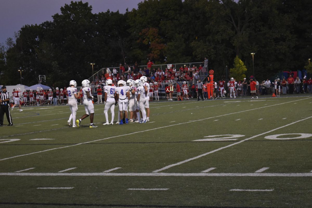 GAMEPLAN. The Wolfpack offense huddles up to discuss what play they are running.