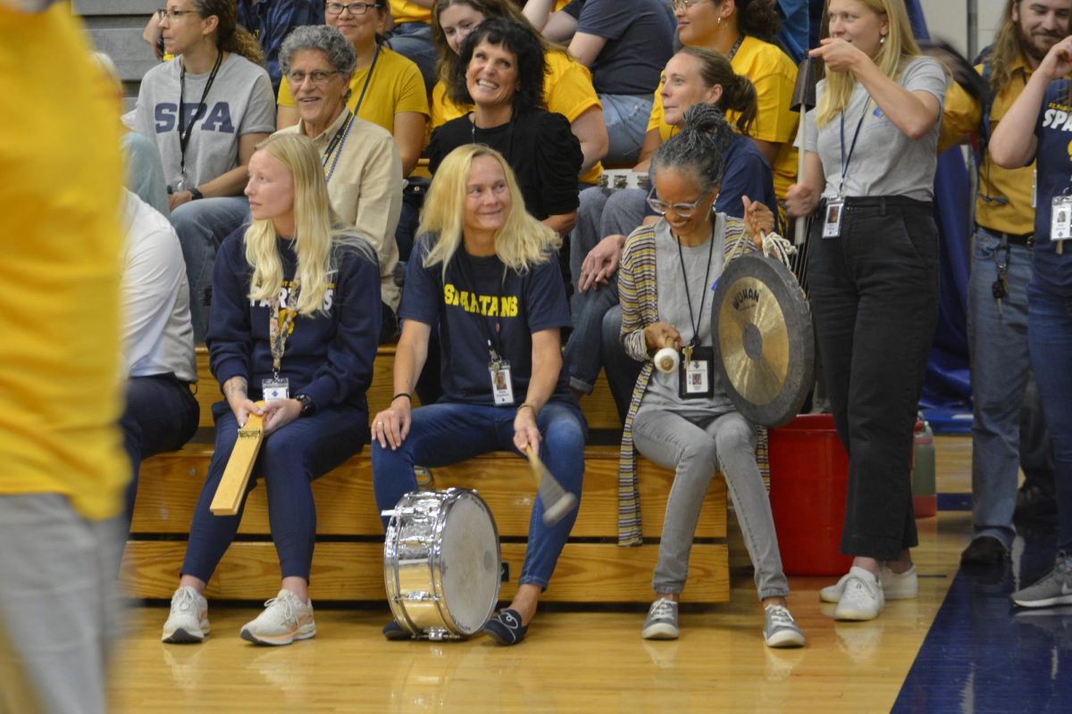 BACKGROUND MUSIC. While ping pong takesa break for the players to reset, English teacher Jacqueline Wigfall and Orchestra teacher Almut Engelhardt share a laugh while playing the percussions. 