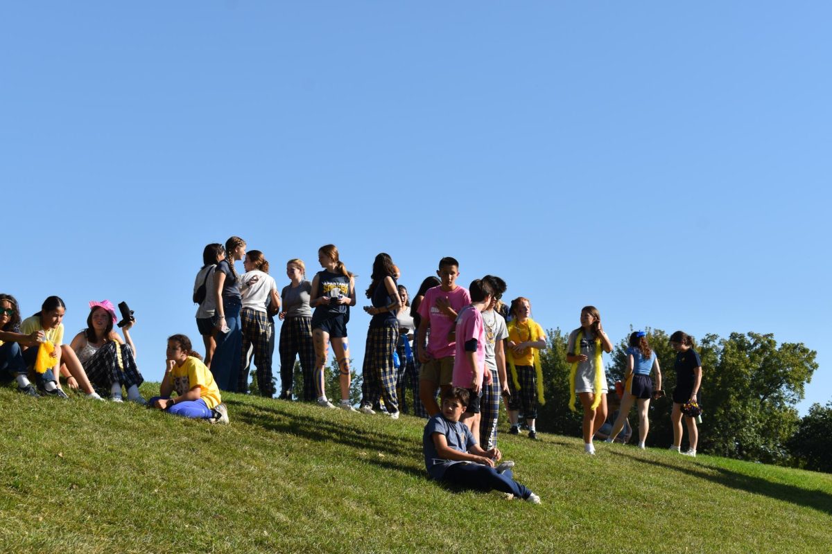 WALKING UP. Scores of students begin walking up the hill at around four p.m.