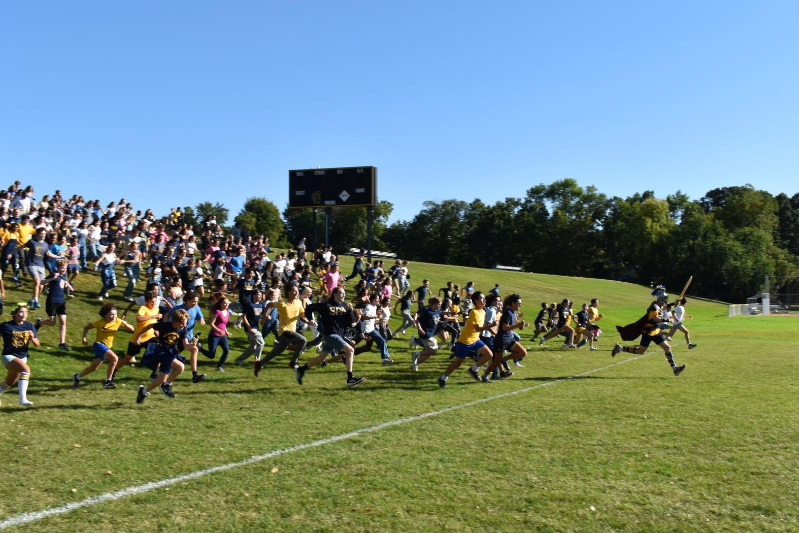 CHARGE. The Spartan leads the way as everybody sprints down the hill towards Lang FIeld, where the soccer game is about to begin.