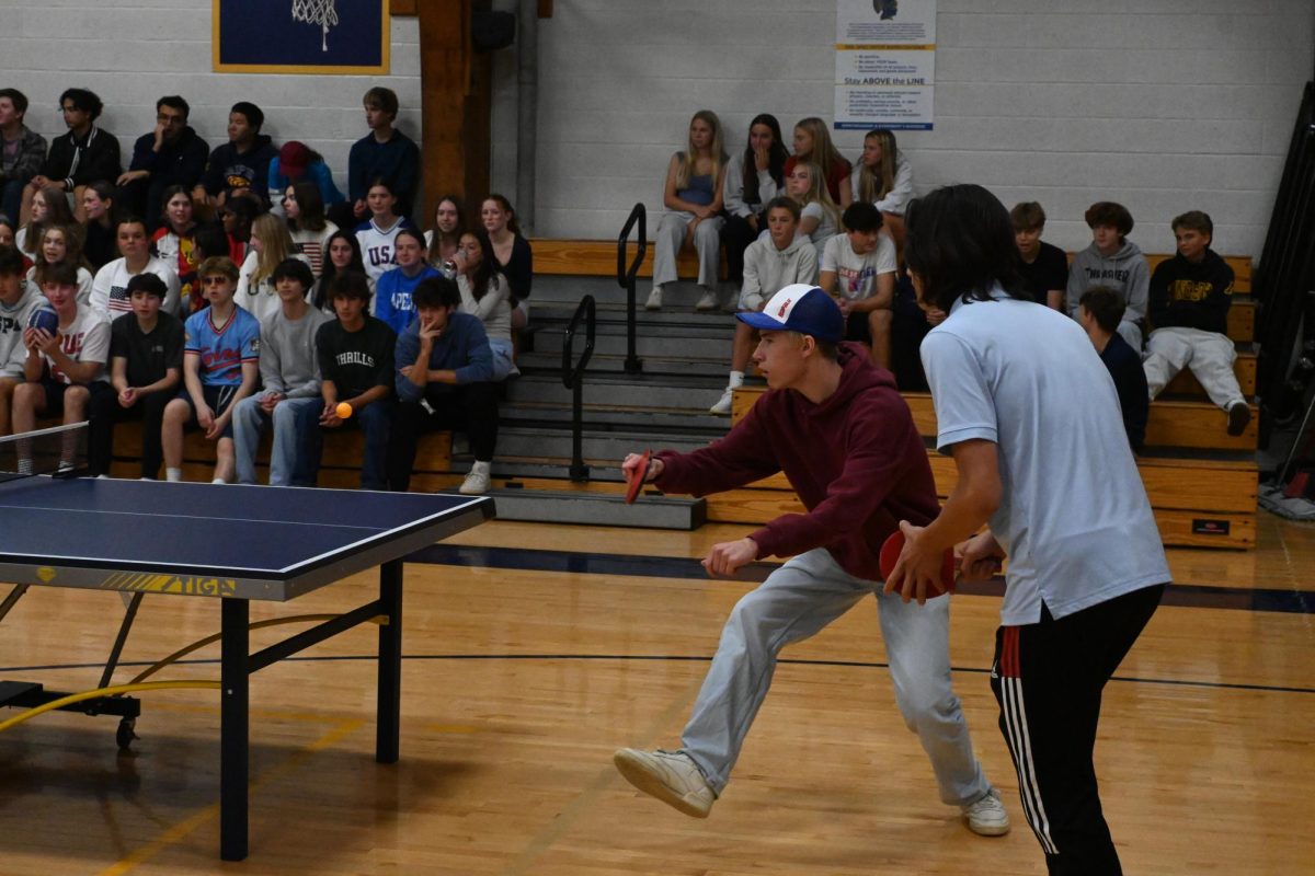 BALL COMING. Senior Andrew Evens hits the ping pong ball back towards the other team.