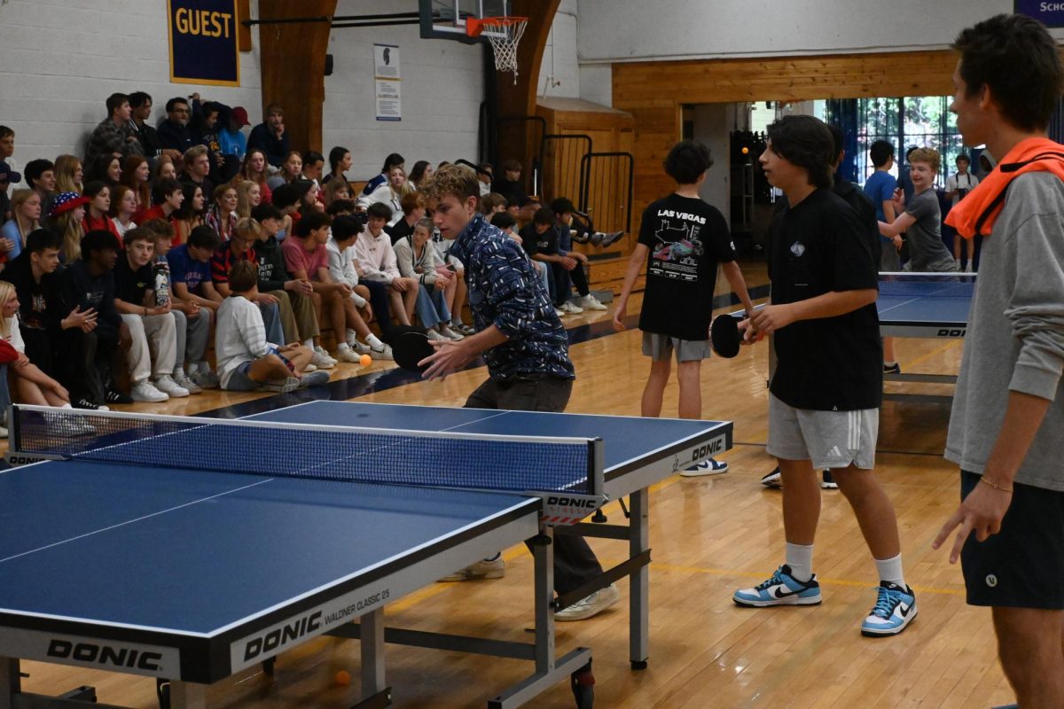 FOREHAND PREP. Senior David Schumacher prepares to hit a forehand as SAC referee Liam Sullivan keeps score.