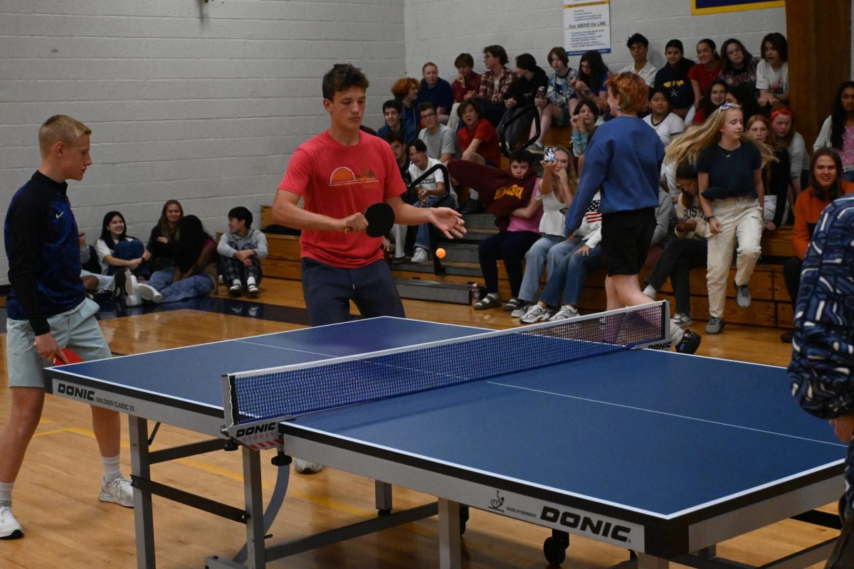 BACKHAND RETURN. Sophomore Sam Hilton returns the ball with a backhand shot back towards his opponents.