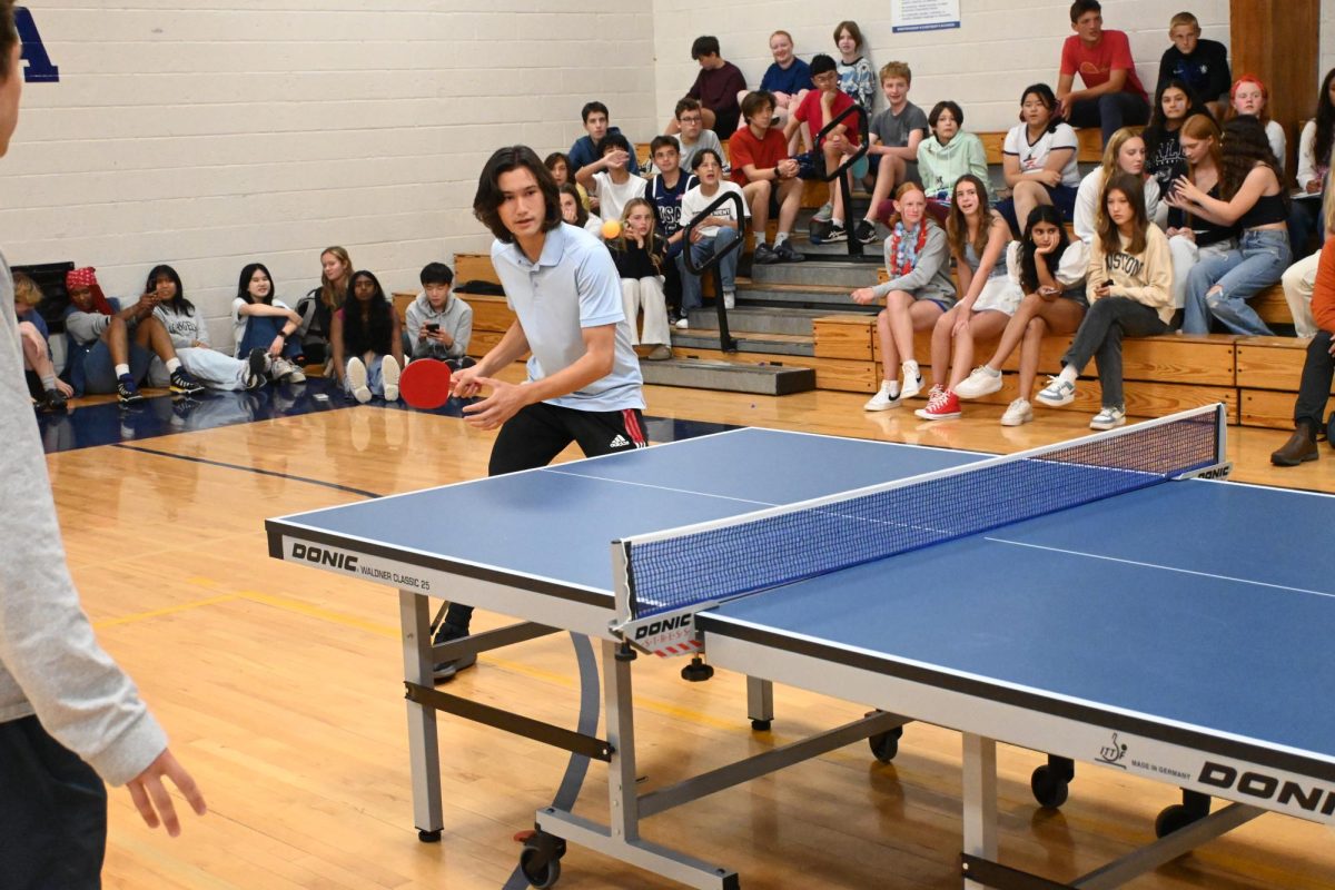 READY. Senior Jacob Colton prepares his forehand as the ball travels towards him.