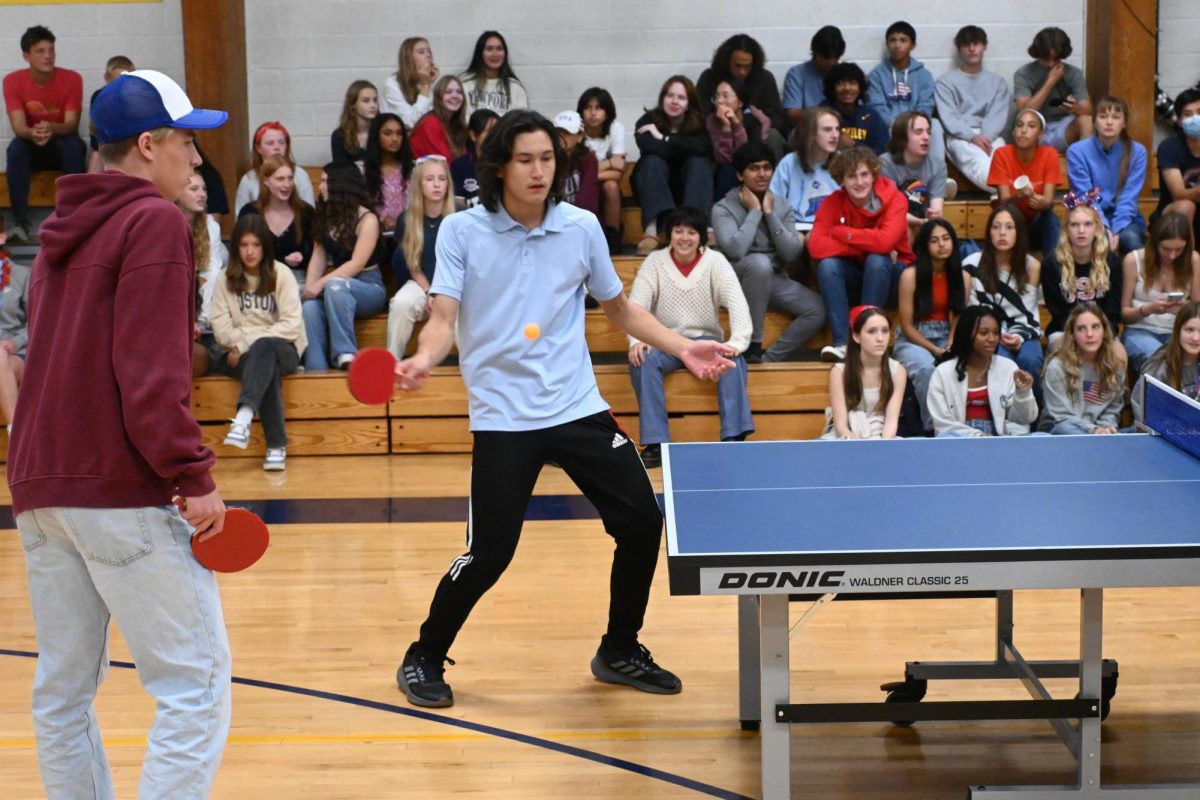 FOREHAND SHOT. Senior Jacob Colton gets ready to hit a forehand shot back over the net.