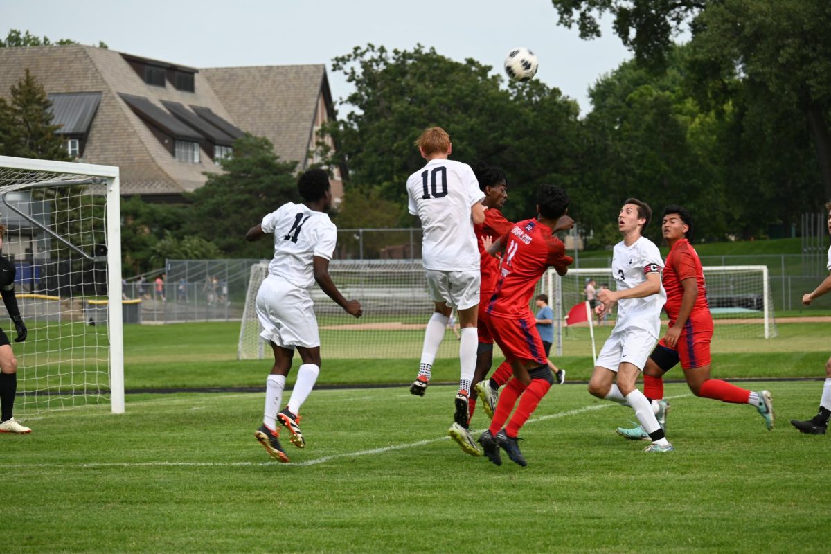 HEADER. Both Spartan and Scot players jump into the air, fighting to head the ball.