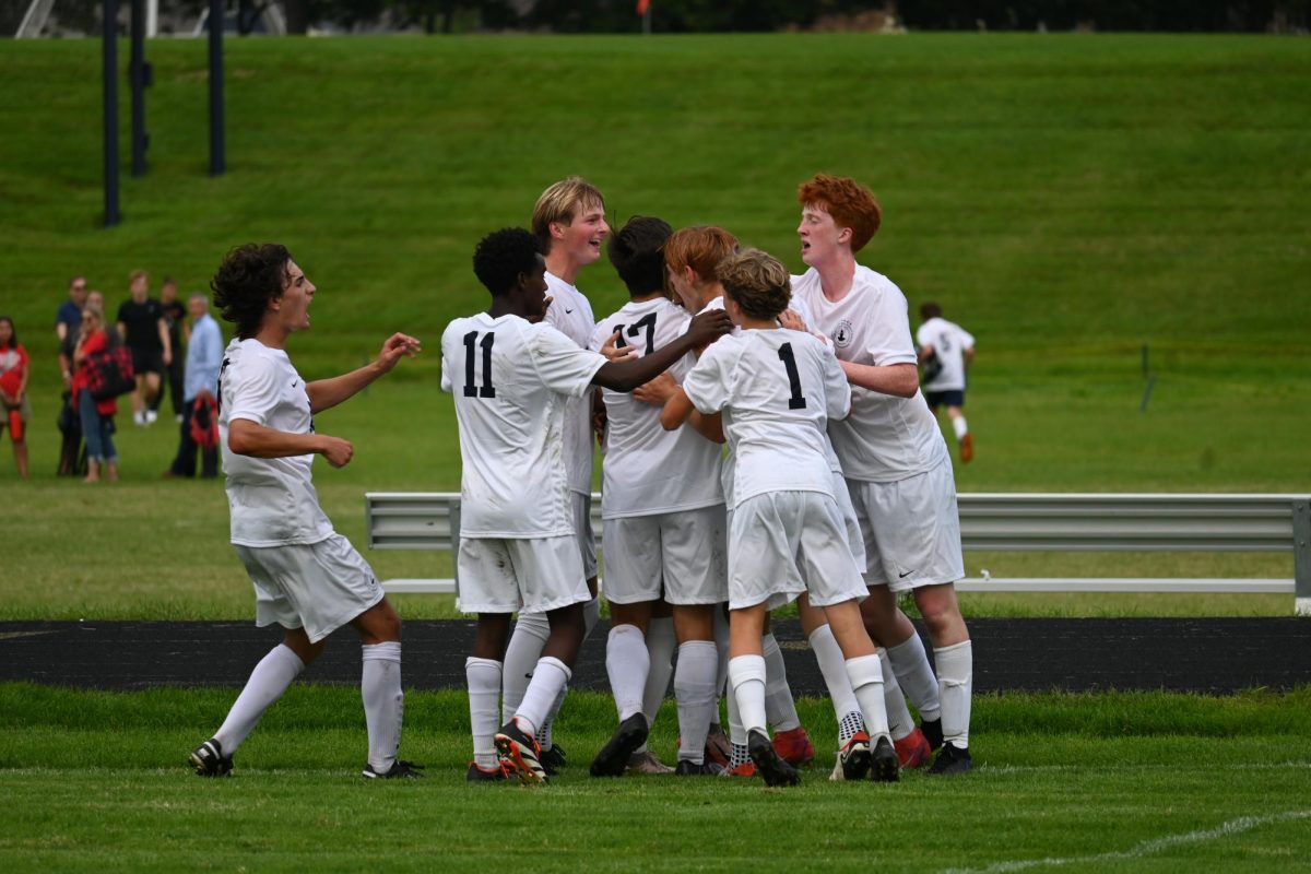 HUG. Spartans celebrate Ethan Peltier's game defining goal in a group hug.