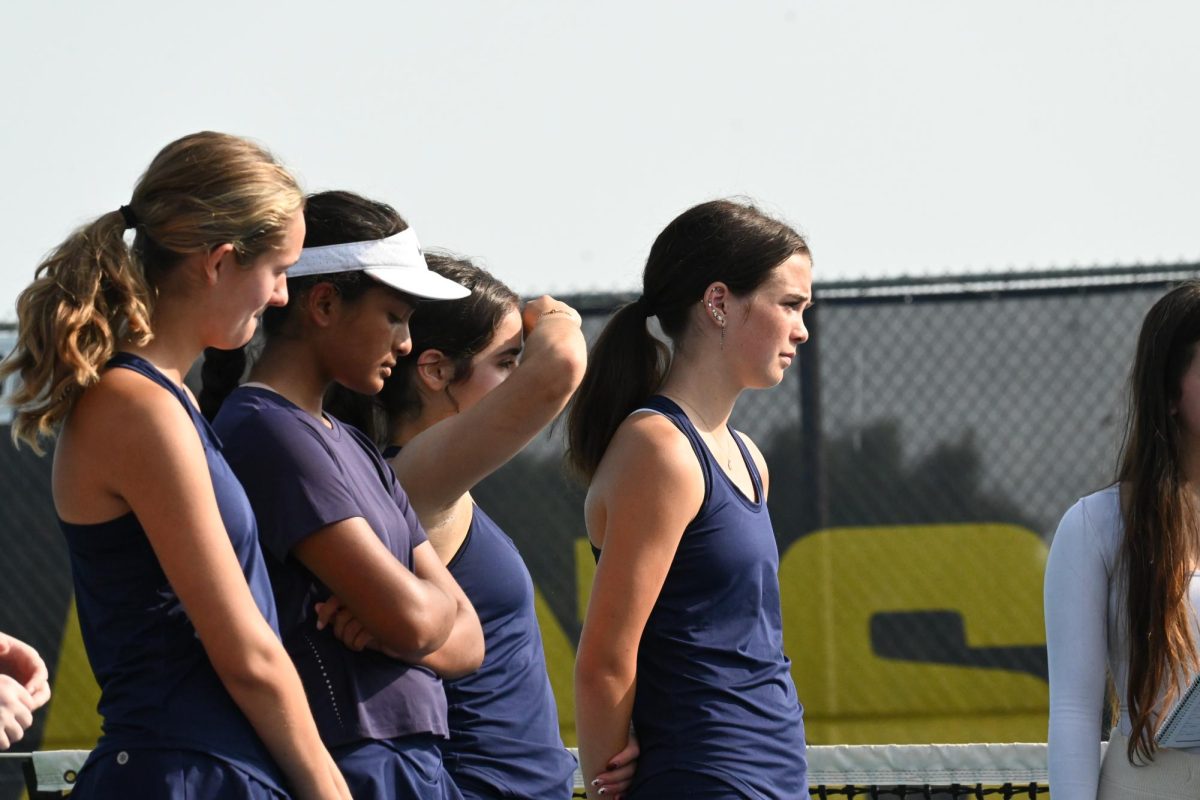 DIALED IN. Larson, the first-ranked singles player for SPA, matches up with Hill Murray's first-ranked player. She stares intensely at the opposing team, and she is ready for the match to commence.