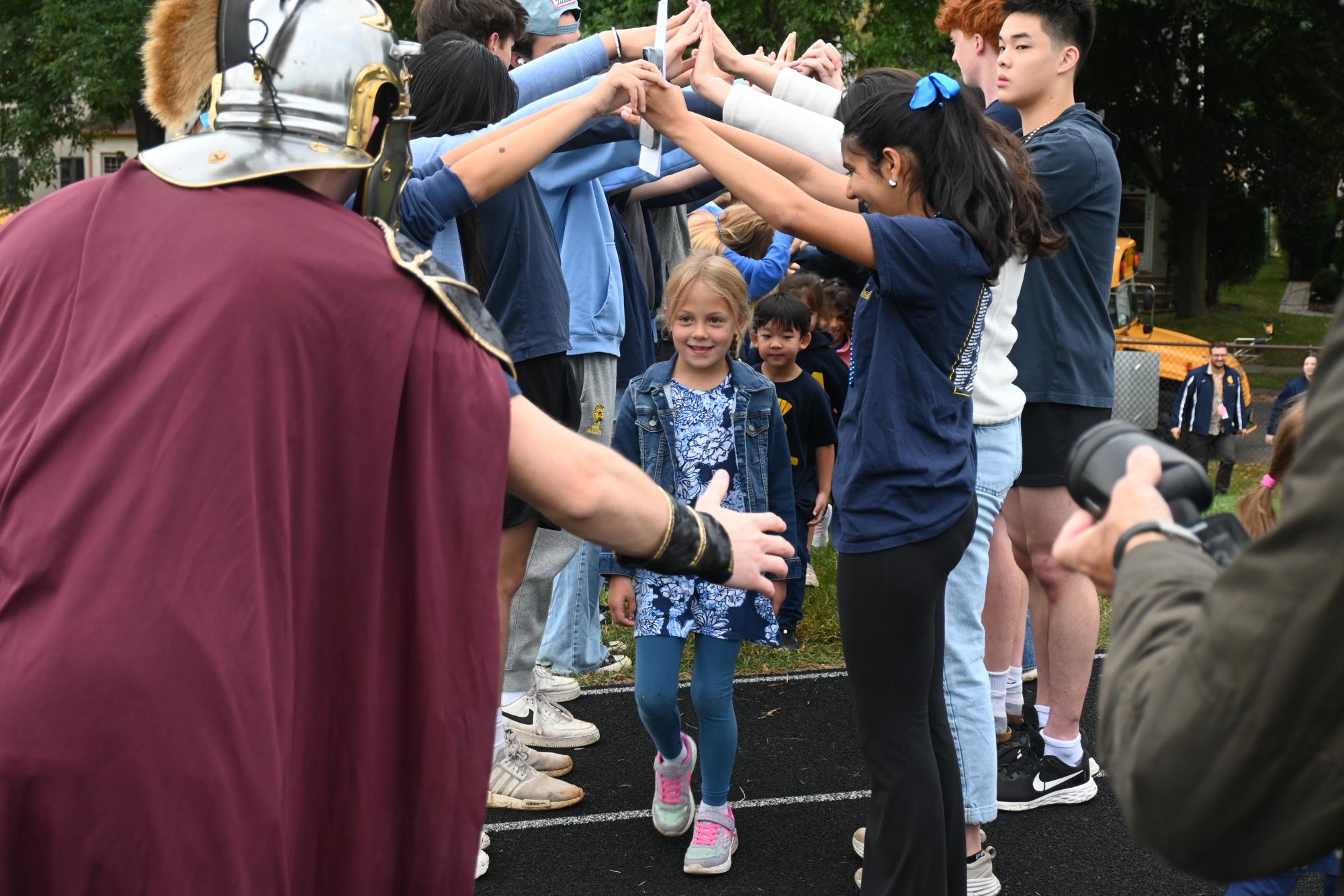 MEET THE SPARTAN. The class of 2027 welcomes the lower school to the assembly.