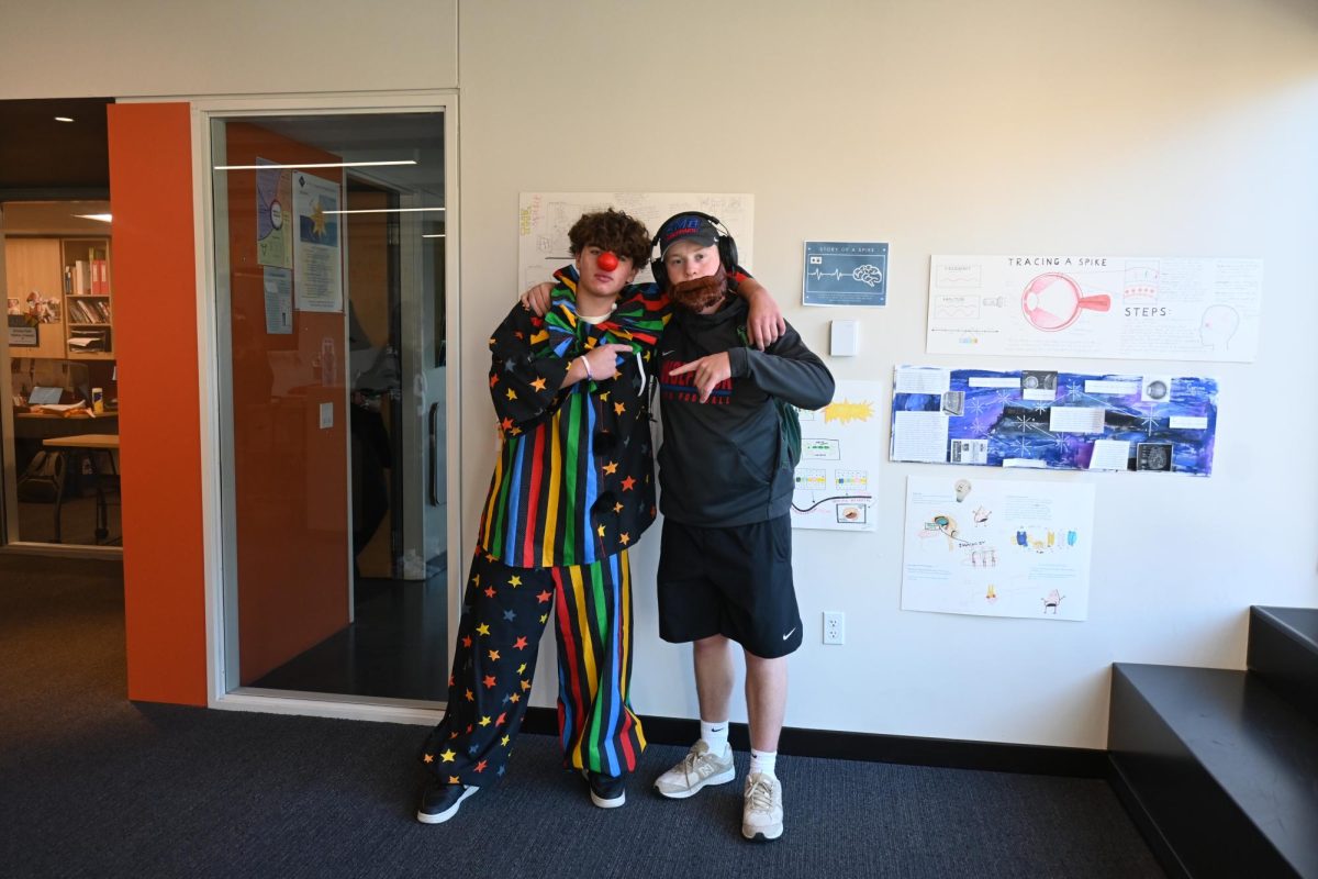 CLOWN AND COACH BROWN. Fletcher Coblentz (left) and Peter Ostrem (right) dressed as a "clown and coach Brown" for their rhyme without reason. Coblentz wears a clown outfit and Ostrem wears a beard and a headset to dress as coach Brown. 