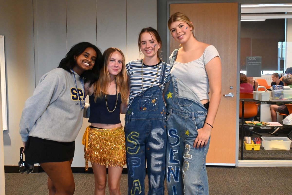 VARIETY. Juniors Luwam Mebrahtu and Lilly Spurgeon and seniors Lucy Thomas and Olympia Wolff (left to right) display their varying outfits for the day. Mebrahtu went for a simple SPA sweatshirt, Spurgeon chose a flashy yellow skirt, while Thomas and Wolff wore  their overalls.