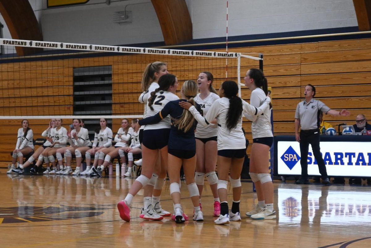 GET HYPE. The volleyball team celebrates after gaining a point against Providence. 