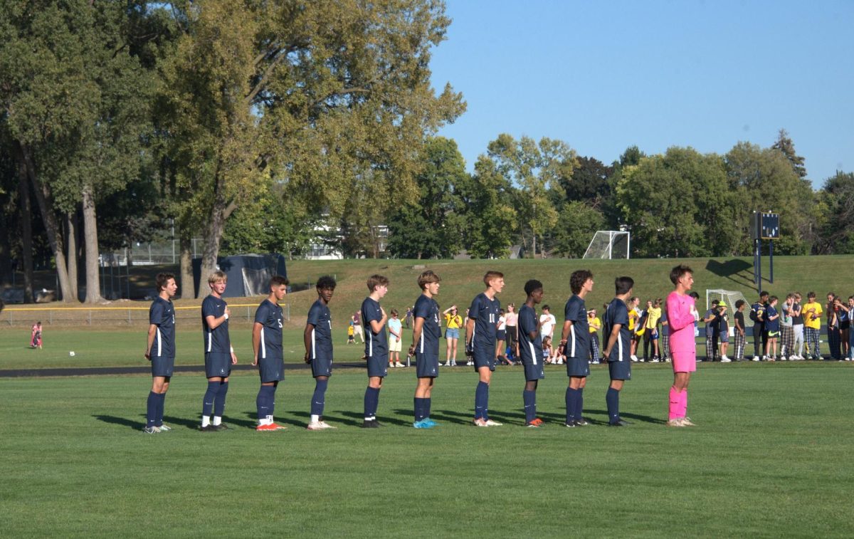 UNITED. The team's starting lineup lined up to sing the national anthem. 