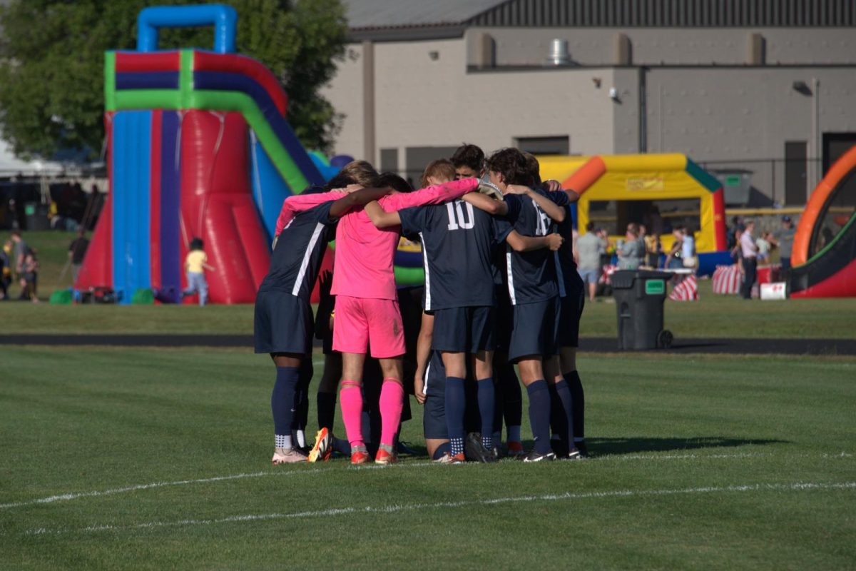 GET HYPED. The team huddles up to get ready before the game starts. 