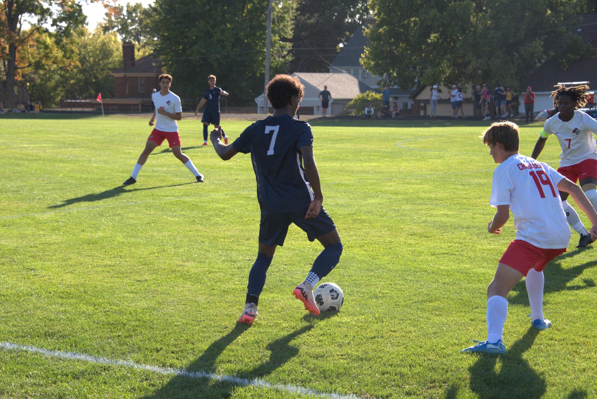 SWARMED. Senior Masumi Kouakou gets possession of the ball while surrounded by opponents. 