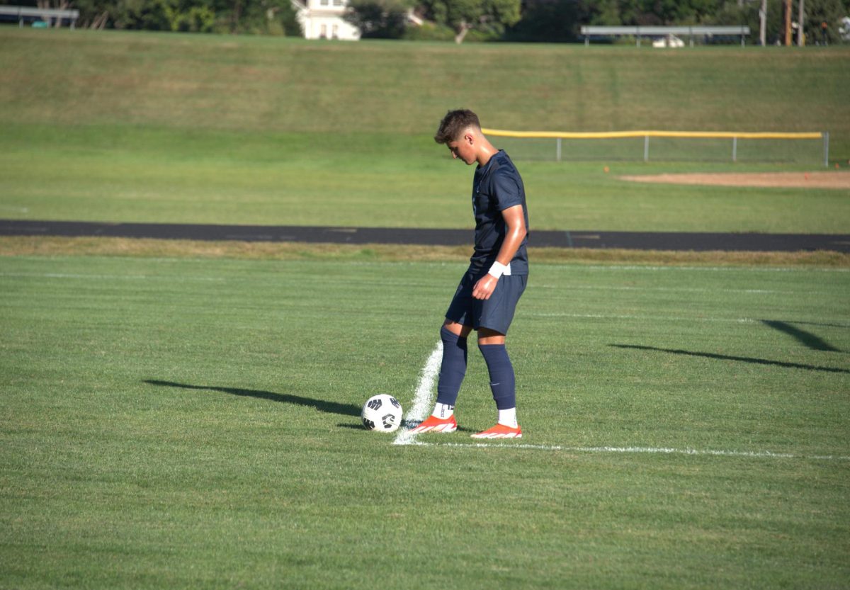 SET IT UP. Sophomore Erik Bjorgvinsson gets ready to kick the ball back onto the field. 