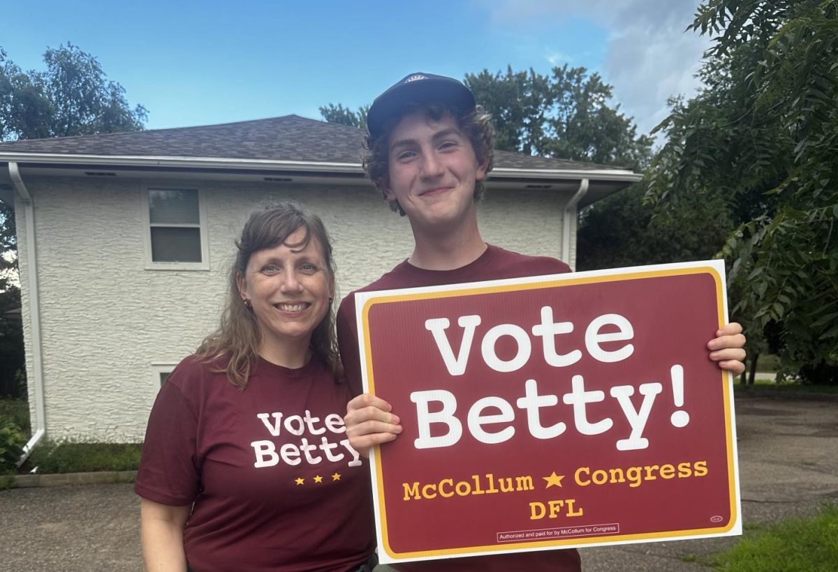 INVOLVED CITIZEN. Junior William Hanna poses with with their "Vote Betty!" sign. Hanna spent this summer volunteering for the Congresswoman Betty McCollum's campaign.