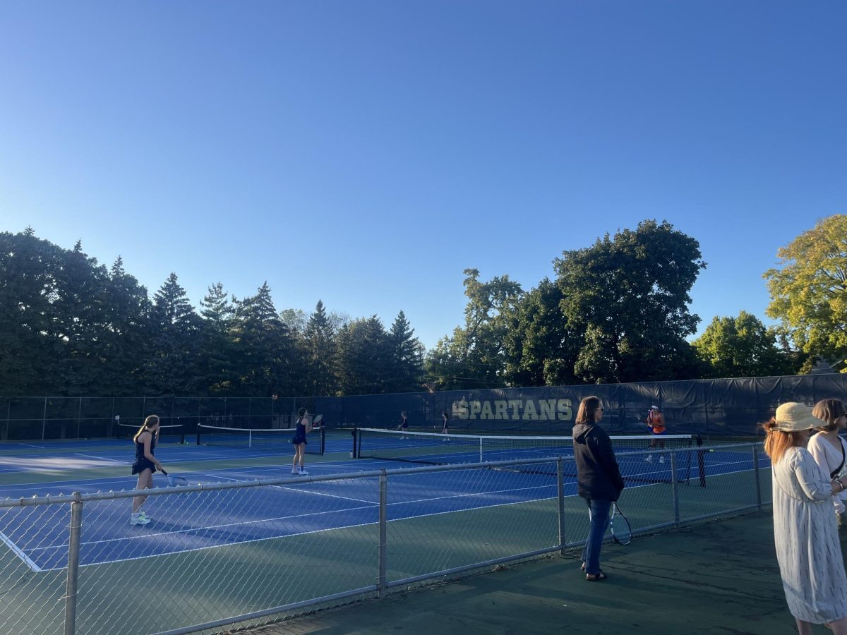 READY TO SWING. Senior Sydney Zimmerman prepares for a serve against Washburn doubles opponents. 