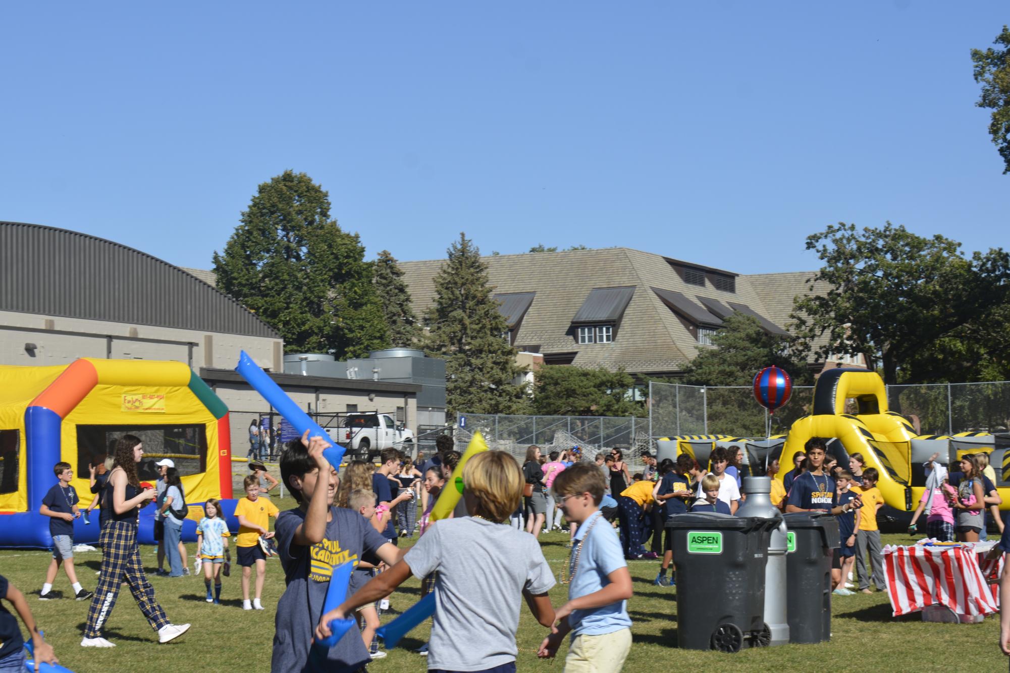 AFTERNOON FUN. Young students enjoy the variety of activities the carnival has to offer, from the inflatable attractions to the spartan colored thunder sticks.
