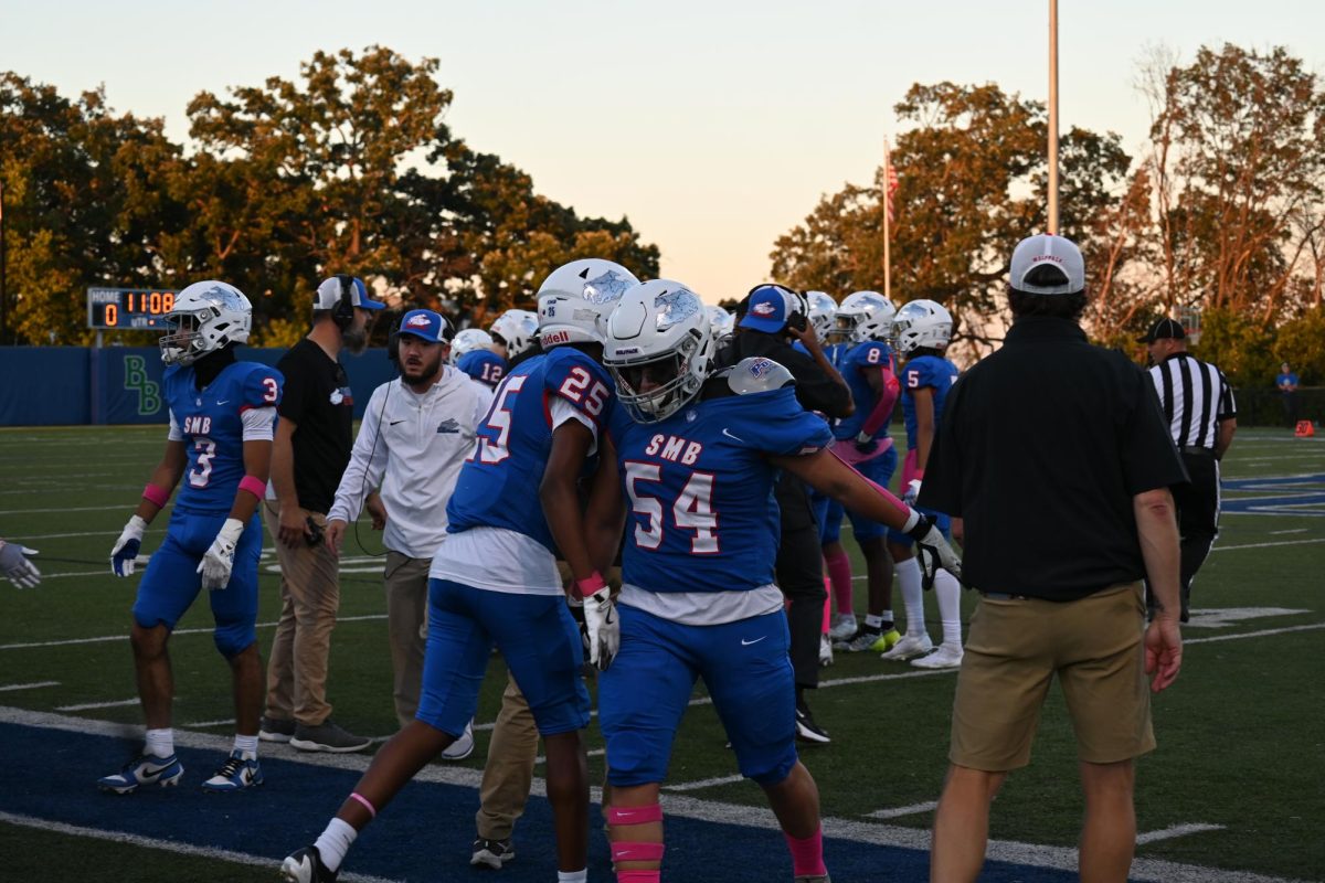 SWITCH PLACES. Players give each other a friendly bump as they switch places on the field. 