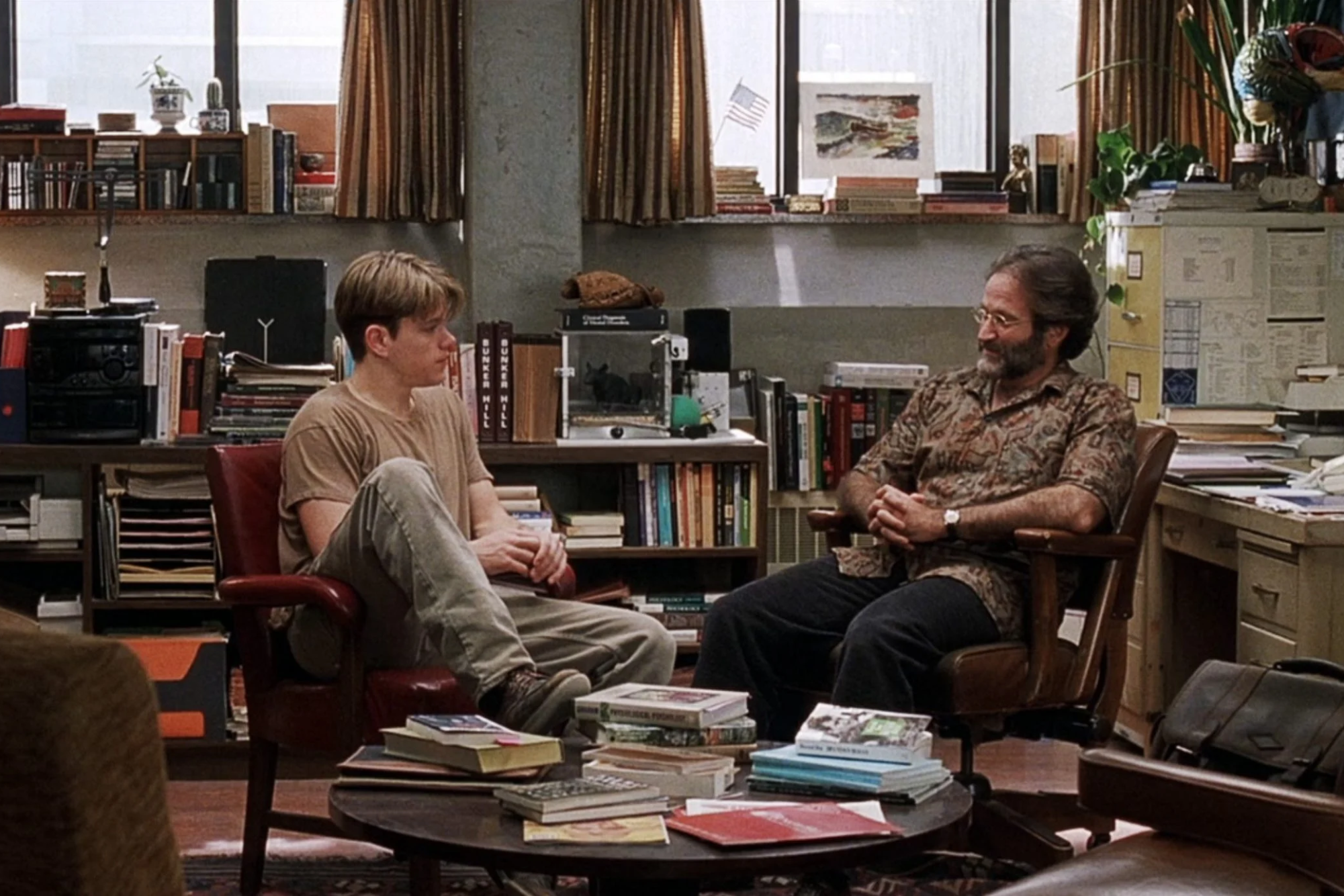 THERAPY. Will Hunting (Matt Damon) and Sean Maguire (Robin Williams) sit in Maguire's office in one of the various therapy scenes in the film. (Screen capture from Miramax)