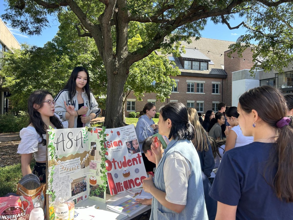 NOT JUST CLUBS. Seniors Deling Chen  and Serene Kalugdan pitch their student affinity group Asian Student Alliance to a faculty member. There are both clubs and affinity groups that students can join, and they meet at different times so that students can be in both. 