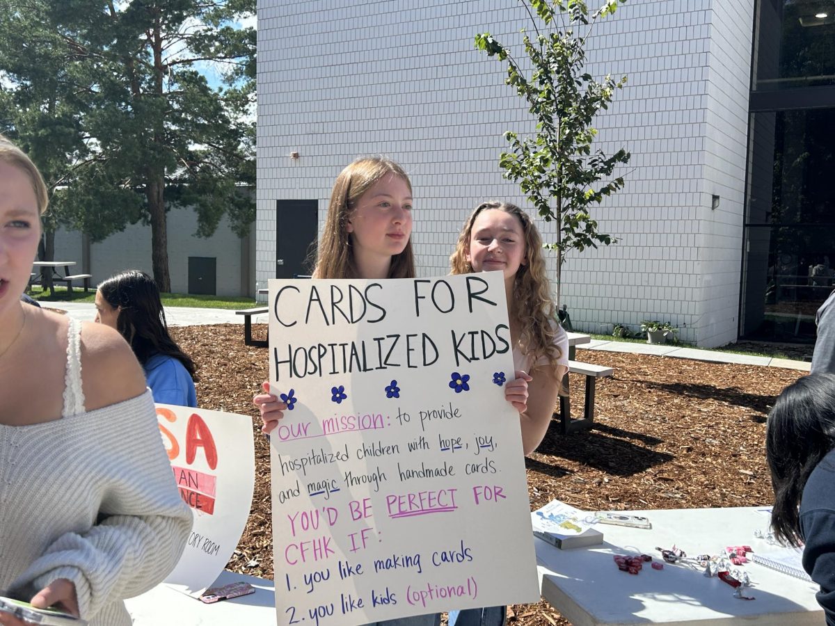 A brief rain shower threatened to send the event indoors, but with the help of Facilities staff, tables were wiped down and groups rushed to prep tables as X-Period began.