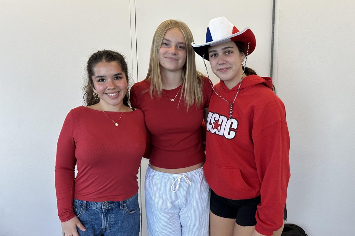 READY IN RED. Sophomores Maisy Torres, Norah Evens and Maddie Wright all wear the color red in order to dress to the USA theme. 