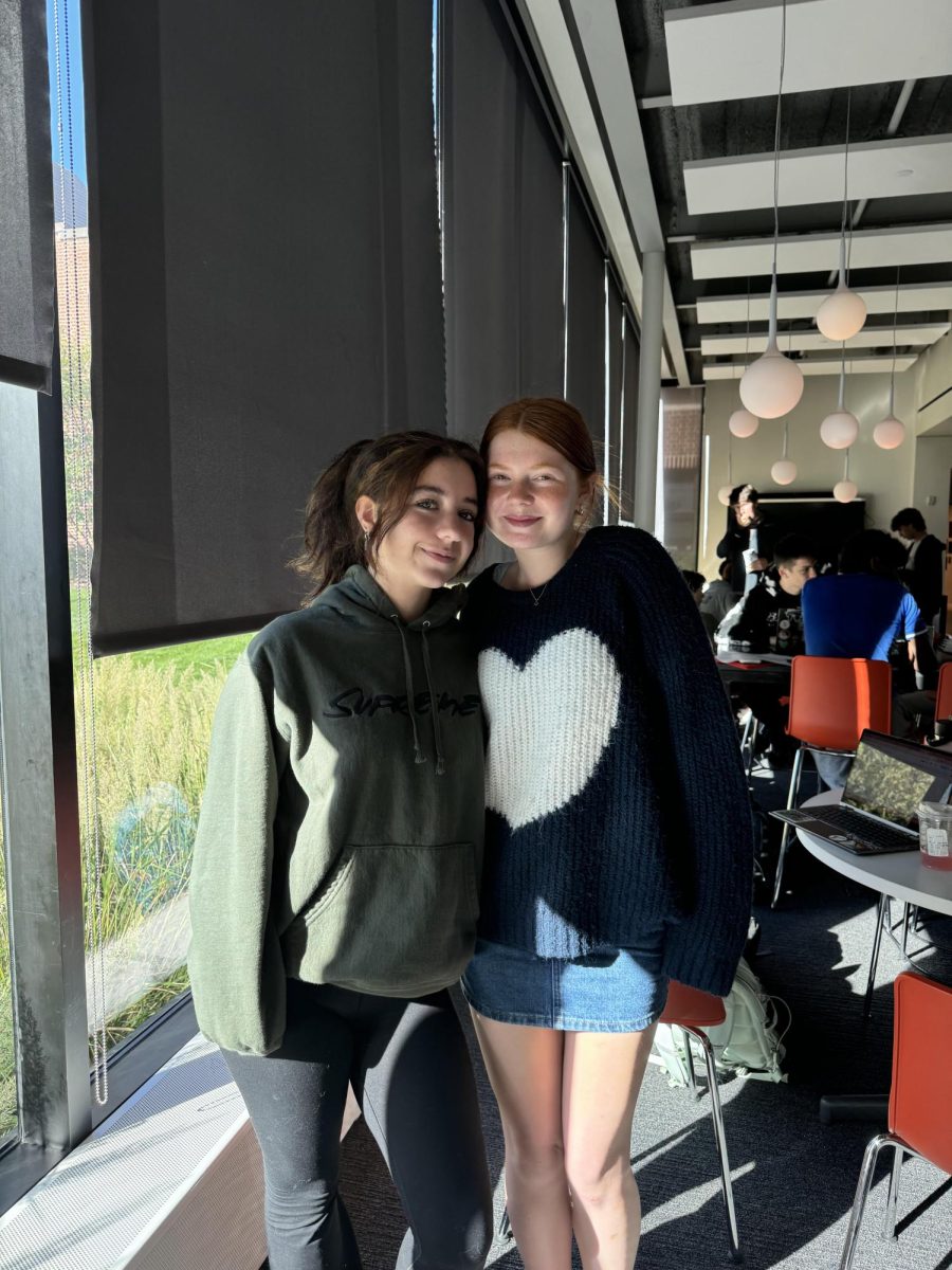 FASHION FORWARD. Junior Liza Thomas (right) bought her sweater after it went viral on TikTok. "I went to the mall with my mom and got it at from an Old Navy Valentine's Day collection," said Thomas.