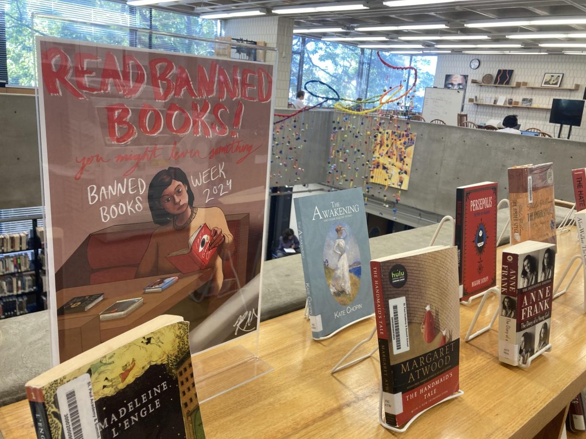 ATTRACTING ATTENTION. Brightly colored posters highlight the display to students in the library.