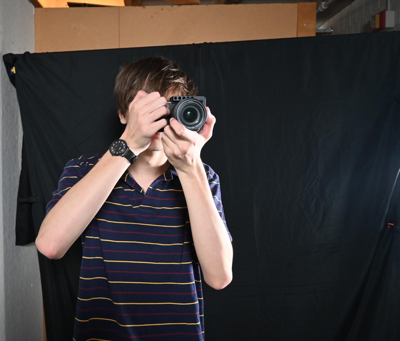 CLICK. Junior Thomas Ferguson lines up the perfect picture with his digital camera. While he prefers the digital camera over his phone camera, he still recognizes it's drawbacks: "It's kind of difficult to work with because the battery dies in 10 minutes," Ferguson said. 