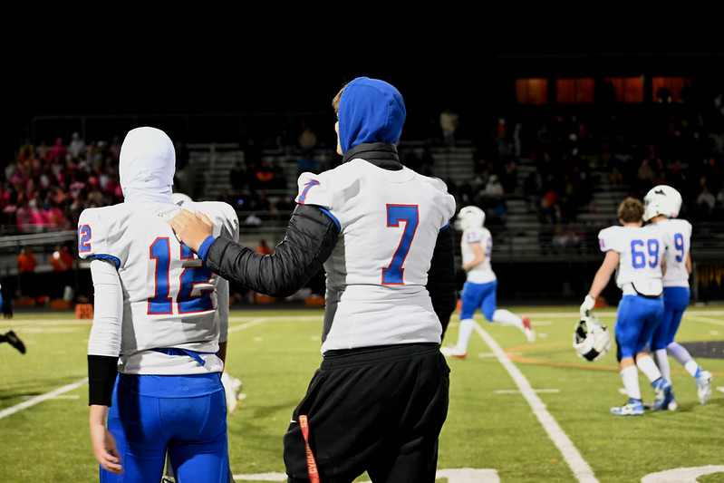 I'VE GOT YOUR BACK. Players walk off the field in pairs after halftime is called.