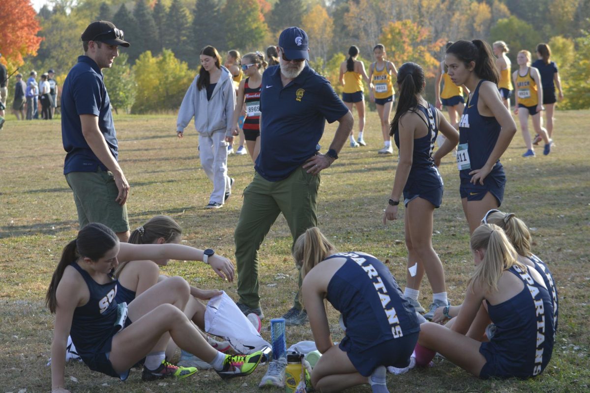 ALMOST TIME. The girls team circle up at the starting line to prepare for the race to begin.