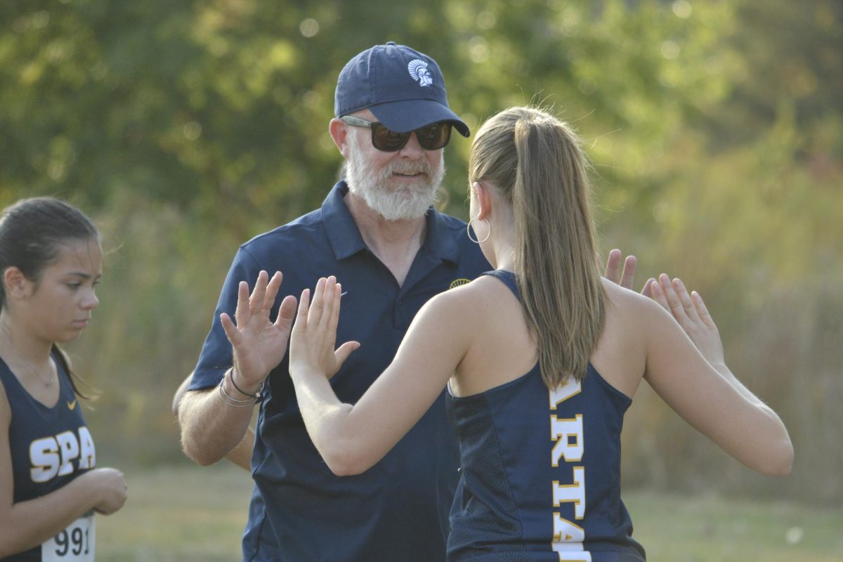 THINK FAST. Coach Ben Bollinger Danielson and senior Taylor Barkwell play a reflexes game before the girls race begins.