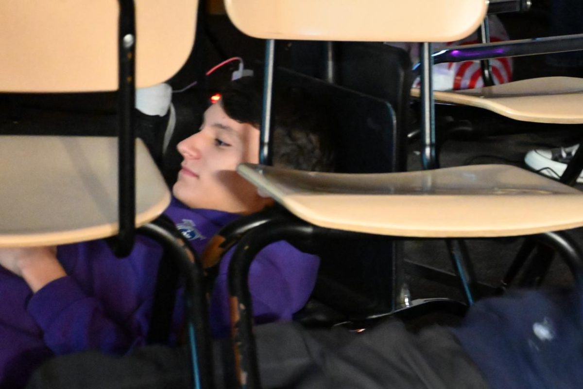 THE FORTRESS OF CHAIRS. Junior Hugh Adams and his friends gather chairs and music stands in Bigelow to build a cozy fort.