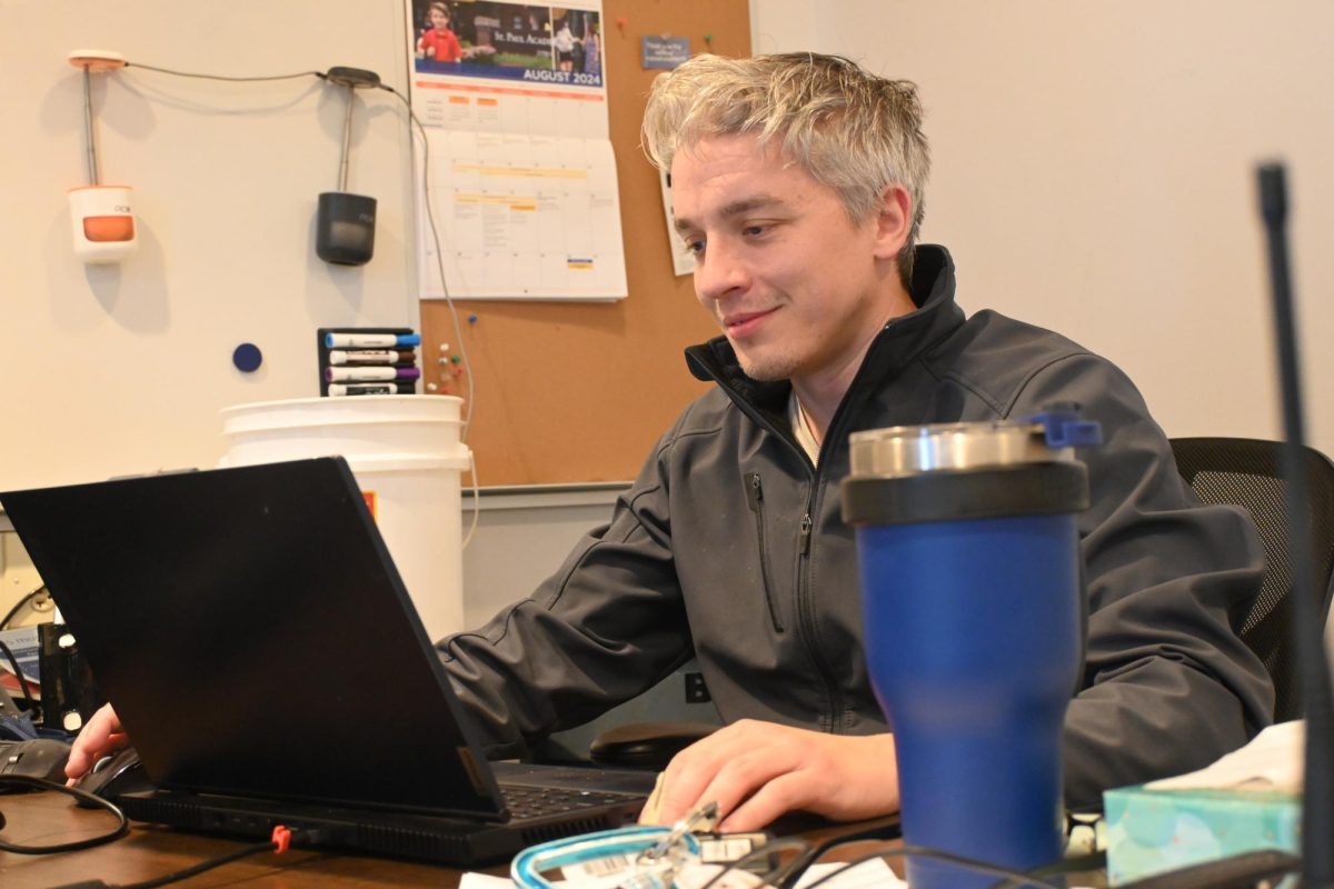 SECURITY SEAMUS. Security Account Manager Seamus Glewwe works on his laptop in the Huss security office. This is his sixth year on the job. He believes the community doesn't know how much time security spends protecting people's cars. "We're noticing people parked in a no parking zone and [that] they're going to get towed. We're noticing that on a snow emergency day, they parked on the wrong side of the road, and we're sending emails and letting people know," Glewwe said.