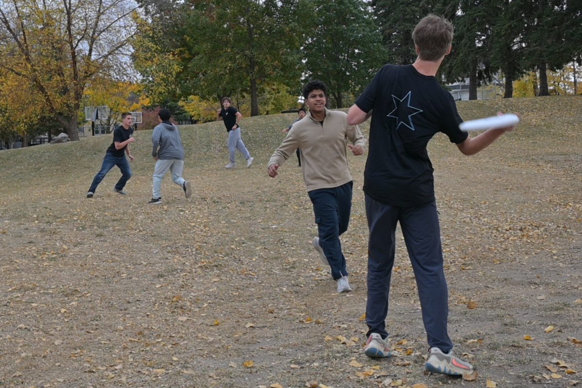 GO LONG. Jesse Wussler throws a side arm throw past the rushing Juan Miguel Adams.