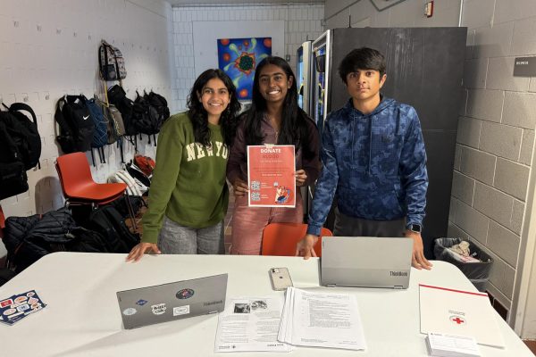 ADVERTISEMENT. USC Co-President Cerena Karmaliani, junior rep. Shefali Meagher and ninth-grade rep. Shrey Nemani (left to right) promote the Blood Drive. They set up a table just outside of the dining hall with flyers and information about donating.