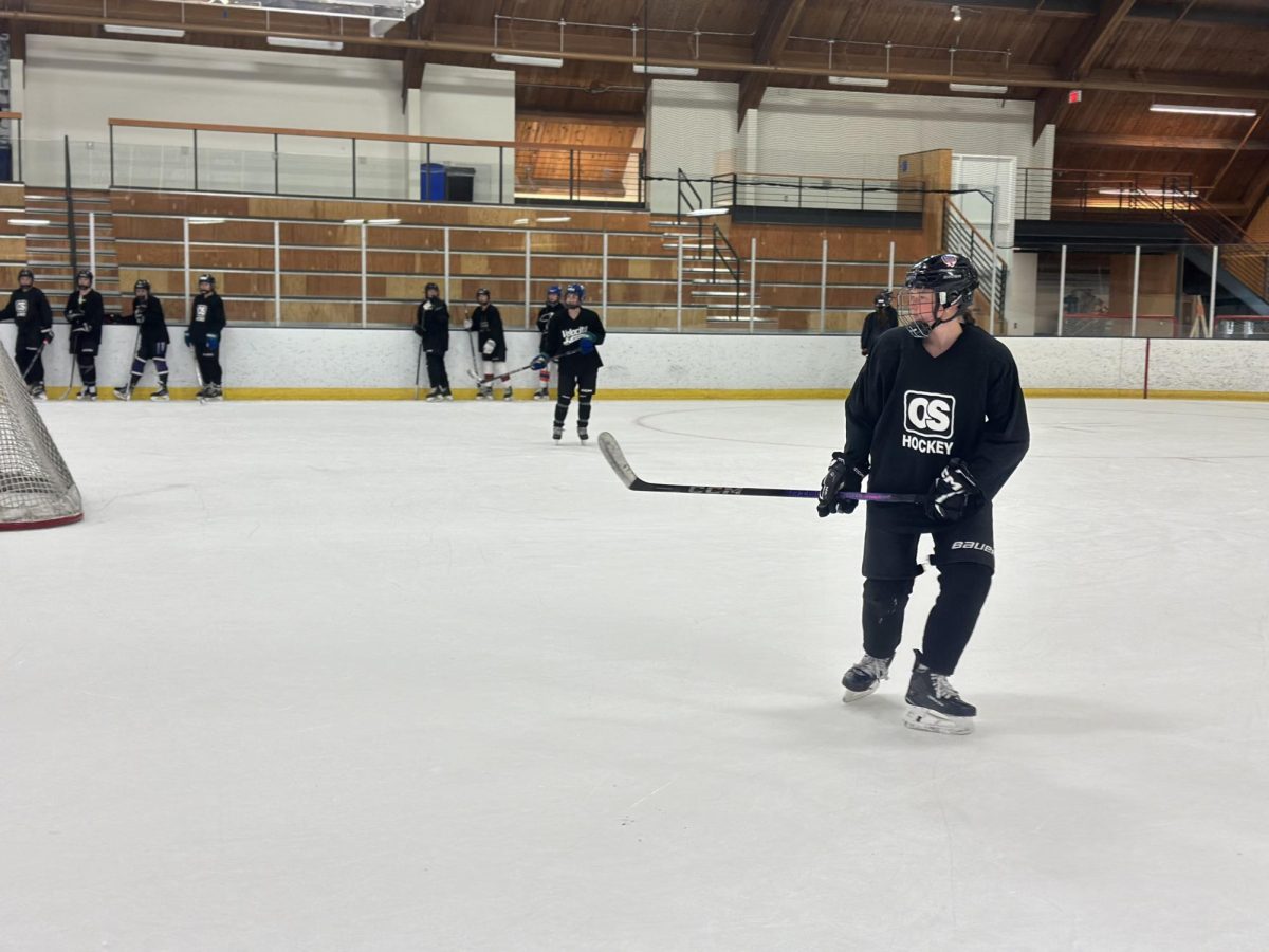 PRE-SEASON HYPE: Junior Ella Bond glides onto the ice at a captains practice in the Blake Bears Arena. Excitement is in the air as players prepare for the upcoming tryouts.