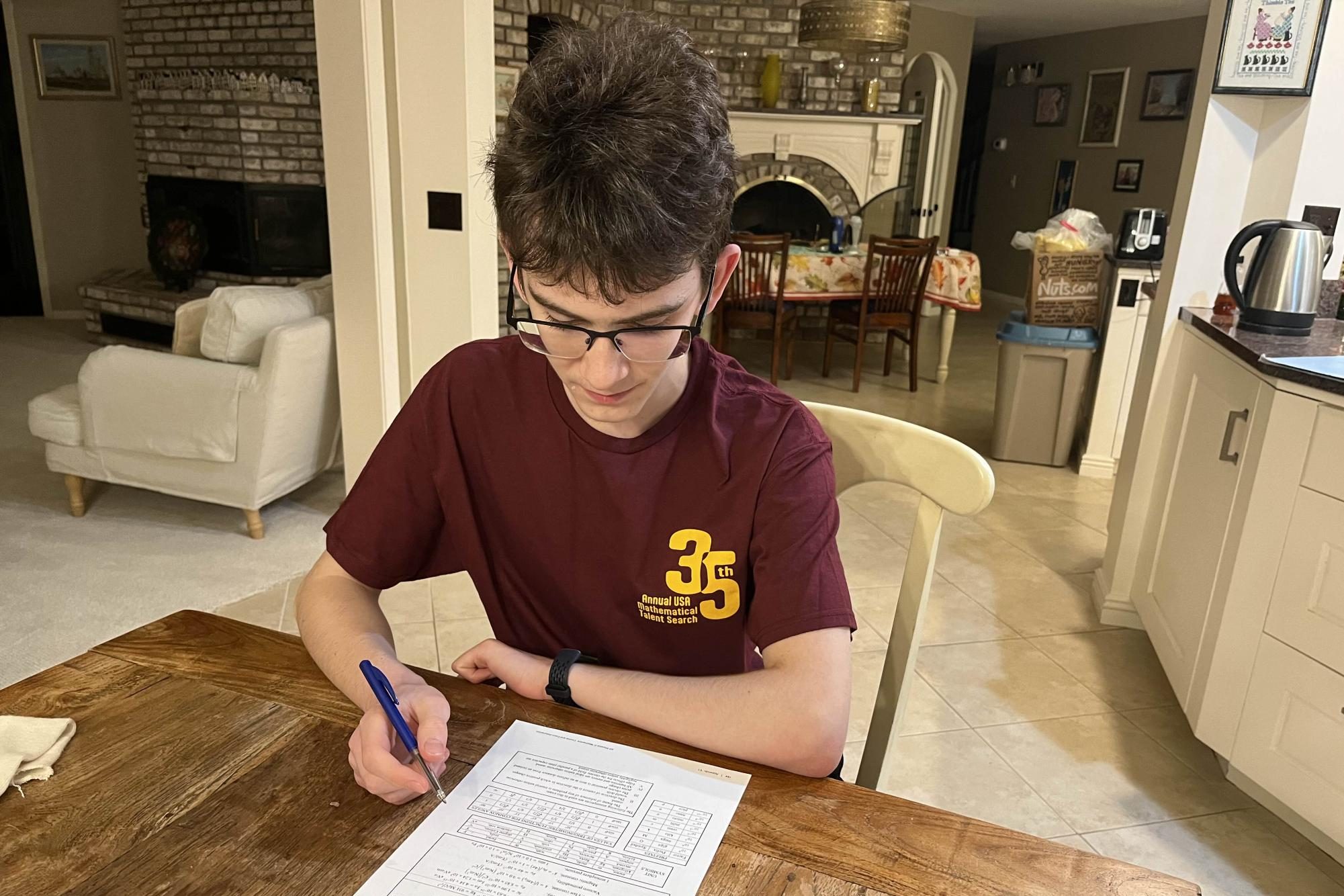 HOMEWORK. Zack Berchenko does Adv. Mechanics with Calculus homework in his living room. Submitted photo: Tara Berchenko