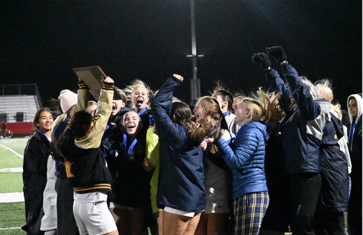 GVS ADVANCES TO STATE. Captain Annie Zhang holds the section win trophy high as the team cheers.