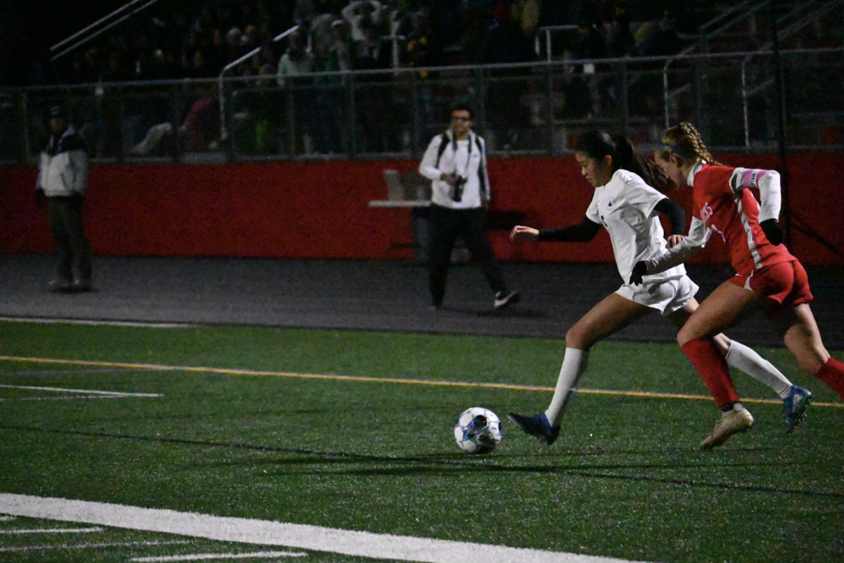 CROSS CONFIGURATION: Ninth-grader Ariella Kim reaches out to strike the ball into the box. Crosses in from the wings popped up frequently throughout the game, and led to many decent scoring chances along the way.