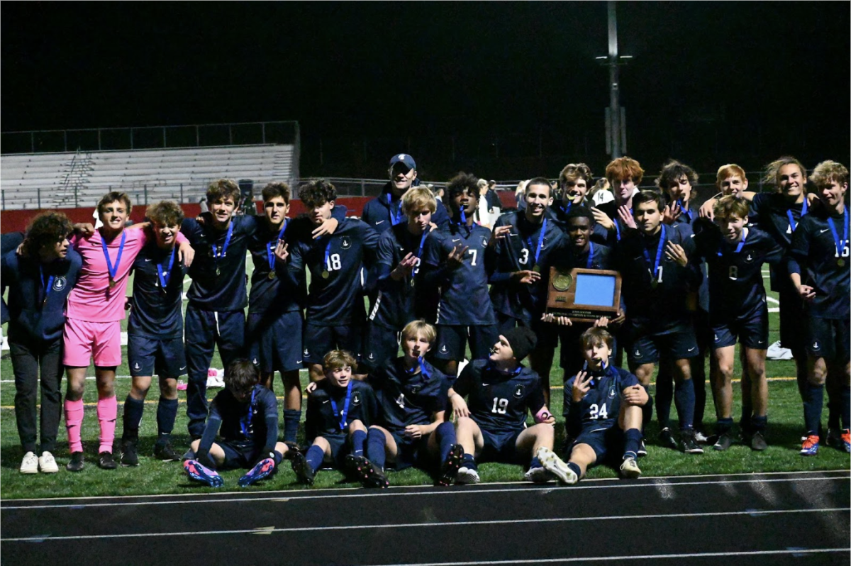 #WINNING. Spartan Varsity Soccer pose with their Section Winner trophy.