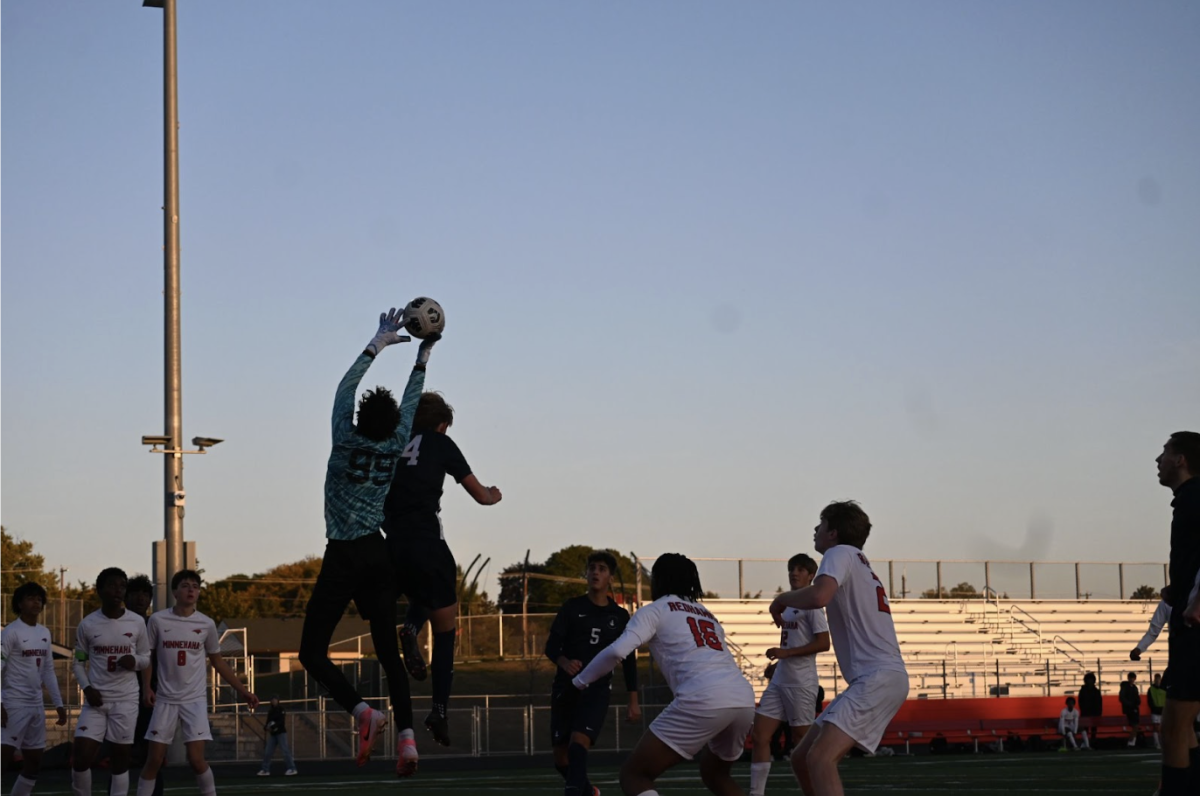 LOOKING UP. Senior Carson Granberg jumps up into the air, attempting to beat the goalkeeper to the ball with a header.